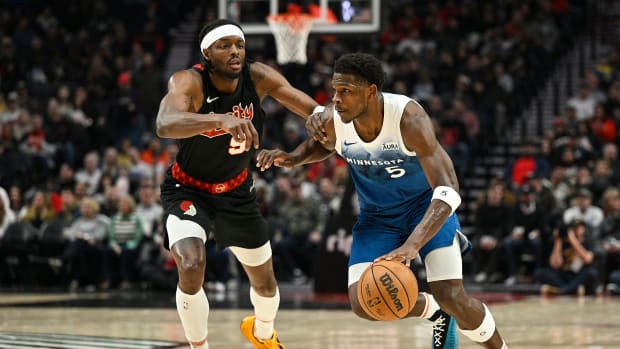 Feb 15, 2024; Portland, Oregon, USA; Minnesota Timberwolves guard Anthony Edwards (5) drives to the basket during the first half against Portland Trail Blazers forward Jerami Grant (9) at Moda Center.